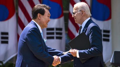US President Joe Biden (R) and South Korean President Yoon Suk Yeol (L) shake hands at a joint press conference in the Rose Garden of the White House in Washington, DC, USA, 26 April 2023