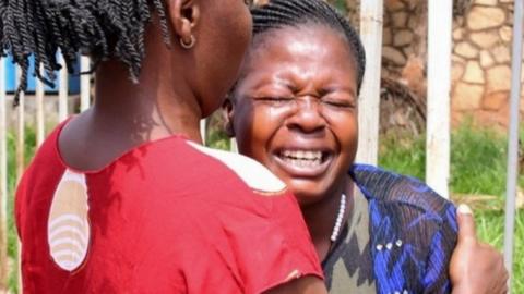 A woman is assisted as she reacts near the scene of a blast in Kampala, Uganda November 16, 2021