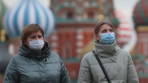Women in protective masks walk in Red Square during the Covid-19 pandemic