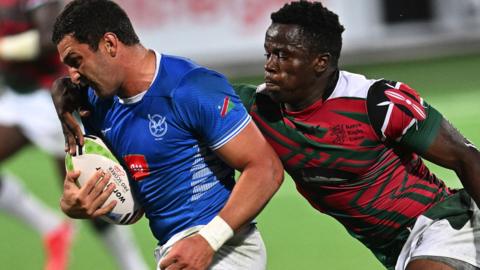 Namibia full-back Divan Rossouw is tackled by Kenya centre John Okoth Okeyo