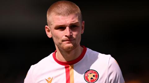 Ryan Stirk playing for Walsall wearing their away kit