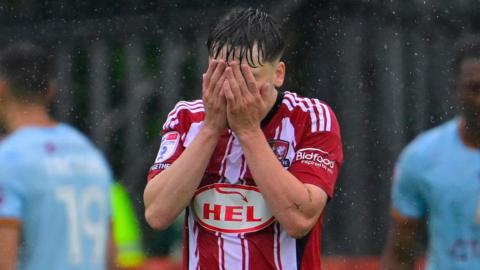 Liam Oakes holds his head in his hands