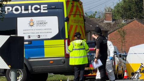 Emergency services staff and vehicles on Aberthaw Road.