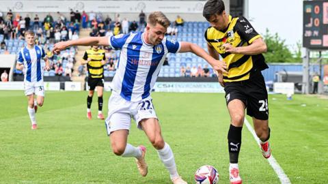 Jack Tucker playing for Colchester United against Barrow