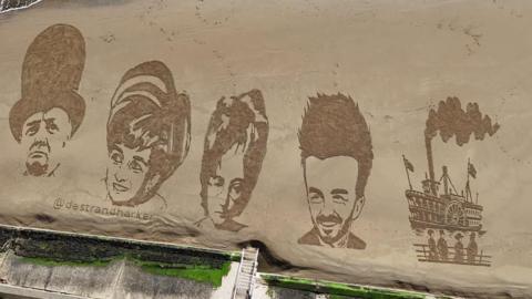 A birds-eye view of a sandy beach with drawings of Winston Churchill, Princess Diana, John Lennon, David Beckham and an old-fashioned ship, all etched onto the surface.