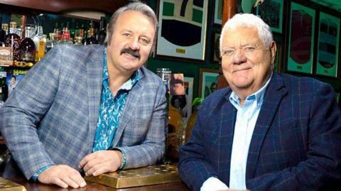 Mike Bubbins (L) welcomes Max Boyce