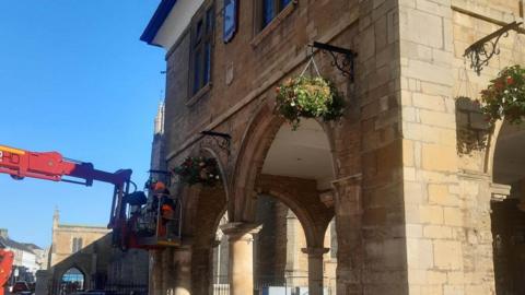 Hanging flower baskets on the frontage of the Guildhall.