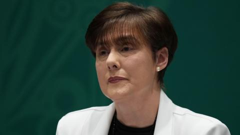 Irish Education Minister Norma Foley wearing a white jacket and a black top during a news conference