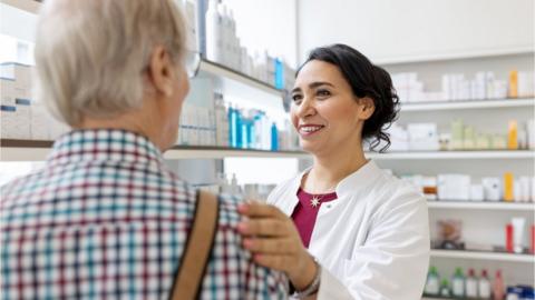 A pharmacist with an elderly patient