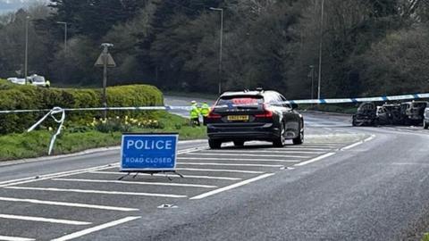 Road closure and police car on A38