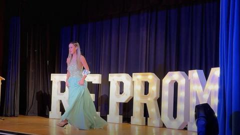 Girl in prom dress on stage