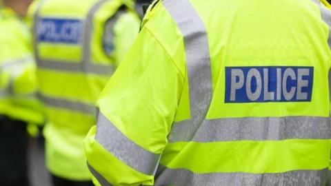 Stock image of police officers with their backs to the camera.