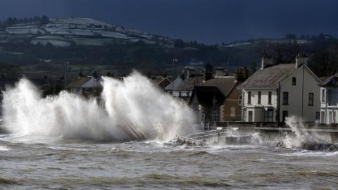 Large waves breaking over the front close to houses in Carnlough in County Antrim in Jan 2014
