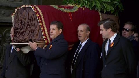 Franco's coffin is carried out of the mausoleum
