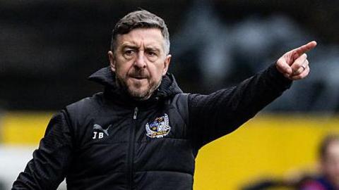 Jon Brady points out some instructions from the touchline during a Port Vale match