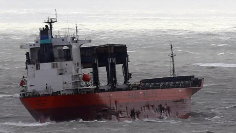 Visible damage along hull of cargo ship