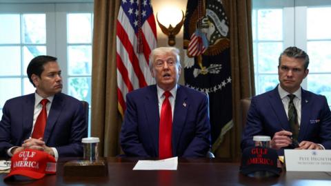 U.S. President Donald Trump speaks next to U.S. Defense Secretary Pete Hegseth and U.S. Secretary of State Marco Rubio during a cabinet meeting at the White House in Washington, D.C.