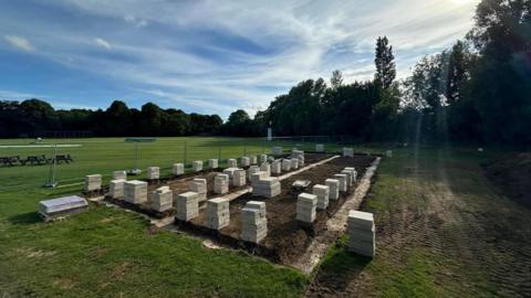 Bricks and tiles on the grass as part of the construction 