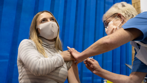 Woman having a vaccine in Cardiff