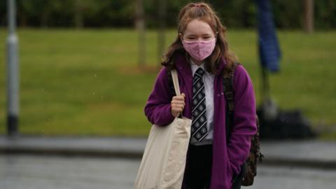 schoolgirl going into school