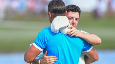 Rory McIlroy hugs playing partner Brooks Koepka on the final day of the World Golf Championships Invitational in Memphis, United States