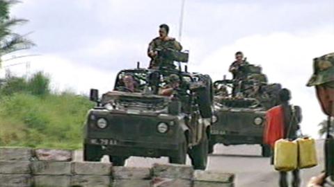 Soldiers driving army jeeps.