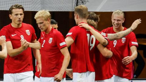 Erling Haaland (right) celebrates scoring with team-mates