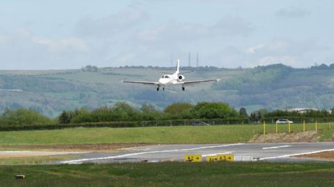 A plane coming in to land on the runway at Gloucestershire airport