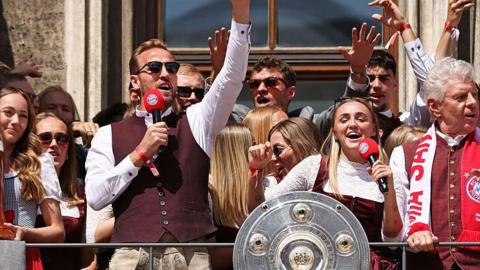 Harry Kane and Georgia Stanway celebrating Bayern Munich's title wins
