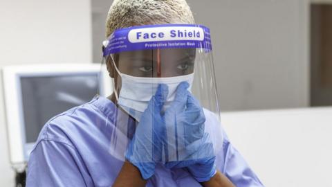 Stock picture of healthcare workers wearing a surgical mask.