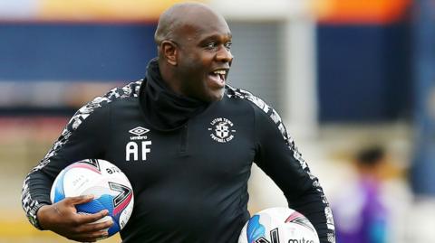 Adrian Forbes holding a couple of footballs during a training session at Luton Town