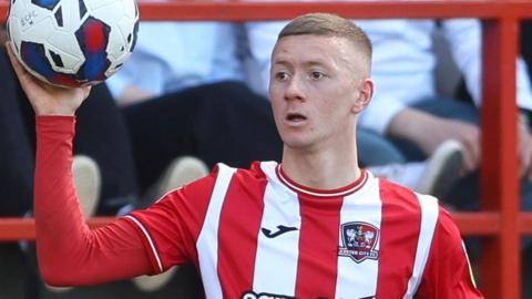 Jay Stansfield holding a ball during his time with Exeter