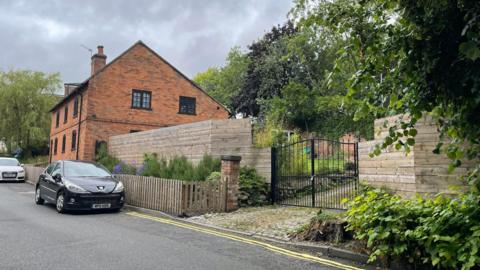 An historic cottage and the new fencing erected next to it