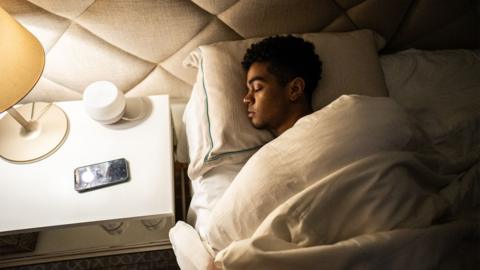 Young man sleeping at home - stock photo