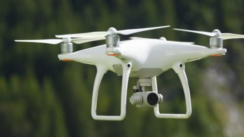Flying drone with camera - stock photo