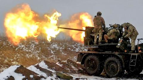 Ukrainian soldiers fire an anti-aircraft gun at a position near Bakhmut, Donetsk region, eastern Ukraine, on 4 February 2023