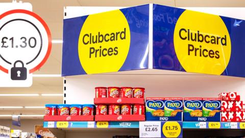 Tesco clubcard signs in a store
