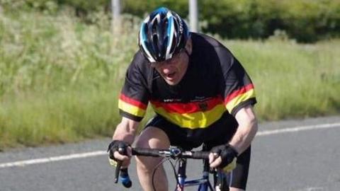 A man riding a bicycle on the road.