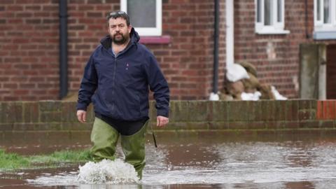 A man walks through flood water in East Cowick