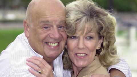 File photo dated 21/09/00 of Coronation Street actors John Savident as Fred Elliott and Sue Nicholls as Audrey, during filming of a special edition of the TV soap opera in Paris France