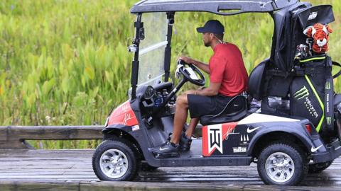 Tiger Woods driving a golf cart