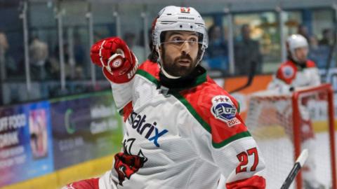 Kristoff Kontos celebrates scoring with one gloved first raised at shoulder level