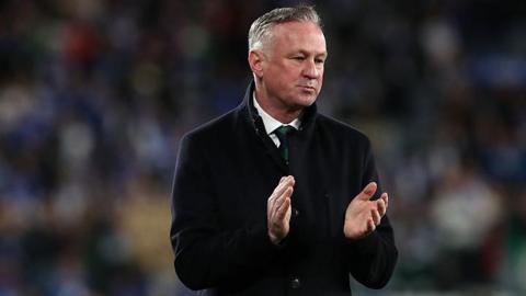 Michael O'Neill applauding on the touchline