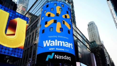 A screen displays the Walmart logo during the opening bell ceremony at the Nasdaq Market to celebrate the company’s listing transfer, in New York City, U.S., December 9, 2025.