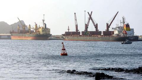 Large cargo ships standing still in ocean water