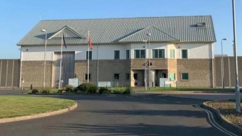 The exterior of the Isle of Man Prison on a sunny day