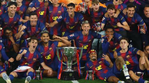 Barcelona celebrate with the trophy