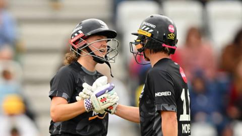 Kathryn Bryce and Beth Mooney shake hands