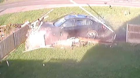 Car crashed through a garden fence.