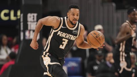 Atlantic Hawks' CJ McCollum dribbles the basketball